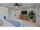 Bright main bedroom with a view to the primary bath with wood flooring, and a ceiling fan at 18 W Kaler Dr, Phoenix, AZ 85021