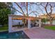 Inviting outdoor living space featuring a covered patio with dining and seating areas by the pool at 18 W Kaler Dr, Phoenix, AZ 85021