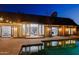 Stunning backyard pool reflecting the home's architecture and interiors through large glass doors at 18 W Kaler Dr, Phoenix, AZ 85021