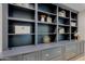 Custom built-in shelving unit offering ample storage and display space with lower cabinets at 18 W Kaler Dr, Phoenix, AZ 85021