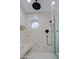 Shower with glass door, bench, round window, and matte black hardware at 18 W Kaler Dr, Phoenix, AZ 85021