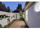 Private side yard with brick pavers, mature plants, and architectural details offer a tranquil escape at 18 W Kaler Dr, Phoenix, AZ 85021