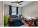 Cozy bedroom with a ceiling fan, dark blue accents, and grey laminate flooring at 18250 N Cave Creek Rd # 180, Phoenix, AZ 85032