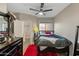 Comfortable bedroom featuring a ceiling fan, natural light, and closet storage at 18250 N Cave Creek Rd # 180, Phoenix, AZ 85032