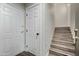 Bright entryway with white doors, wood-look floors, and stairs leading up to the main living area at 18250 N Cave Creek Rd # 180, Phoenix, AZ 85032