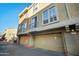 Tan multi-story building features private garages with large windows providing natural light on a clear sky day at 18250 N Cave Creek Rd # 180, Phoenix, AZ 85032