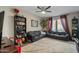 Inviting living room with plush carpet, modern ceiling fan, and stylish decor and two dark leather sofas at 18250 N Cave Creek Rd # 180, Phoenix, AZ 85032