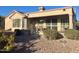 Covered patio with seating area, grill, and landscaping at 18328 N Avalon Ln, Surprise, AZ 85374