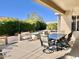 Outdoor patio with table and chairs, lush landscaping at 18328 N Avalon Ln, Surprise, AZ 85374