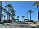 Gated community entrance with palm trees and a clear sky at 18328 N Avalon Ln, Surprise, AZ 85374