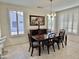 Spacious dining room with wood table, chairs and large windows at 18328 N Avalon Ln, Surprise, AZ 85374