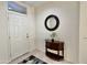 Inviting entryway with a round mirror and console table at 18328 N Avalon Ln, Surprise, AZ 85374