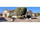 Single-story home with desert landscaping and two-car garage at 18328 N Avalon Ln, Surprise, AZ 85374