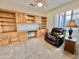 Home office with built-in wooden desk and shelving at 18328 N Avalon Ln, Surprise, AZ 85374