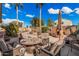 Outdoor patio furniture surrounds a tiled table in this backyard oasis at 19601 N Krupps Ct, Maricopa, AZ 85138