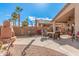 Landscaped backyard with a stone fireplace and patio furniture at 19601 N Krupps Ct, Maricopa, AZ 85138