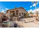 Relaxing backyard patio with seating area, fire pit, and desert landscaping at 19601 N Krupps Ct, Maricopa, AZ 85138