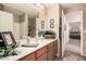 Clean bathroom with wood cabinets and a large mirror at 19601 N Krupps Ct, Maricopa, AZ 85138