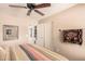 Relaxing bedroom with a ceiling fan and ensuite bathroom at 19601 N Krupps Ct, Maricopa, AZ 85138