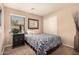 Bedroom with floral bedding and dark wood nightstand at 19601 N Krupps Ct, Maricopa, AZ 85138