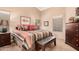 Bedroom with a queen-size bed and dark wood furniture at 19601 N Krupps Ct, Maricopa, AZ 85138