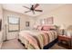 Spacious bedroom with a striped comforter and ceiling fan at 19601 N Krupps Ct, Maricopa, AZ 85138