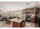 Island kitchen with stainless steel appliances and wood cabinets at 19601 N Krupps Ct, Maricopa, AZ 85138