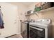 Convenient laundry room with washer, dryer, and shelving at 19601 N Krupps Ct, Maricopa, AZ 85138