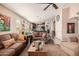 Bright living room featuring comfortable sofas and a large window at 19601 N Krupps Ct, Maricopa, AZ 85138