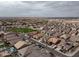 Expansive aerial view of a well-planned residential community with tree-lined streets and lush green spaces, complete with neighborhood parks at 2022 W Briana Way, Queen Creek, AZ 85144