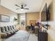 Bedroom with a large window, ceiling fan, and a gray couch and brown walls at 2022 W Briana Way, San Tan Valley, AZ 85144