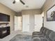 Bedroom with gray couch and brown walls. Doors and closet with doors at 2022 W Briana Way, San Tan Valley, AZ 85144