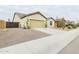 Desert landscaping accents this single-story home with a two-car garage at 2022 W Briana Way, Queen Creek, AZ 85144