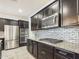 Kitchen with stainless steel appliances, dark cabinets, and granite countertops at 2022 W Briana Way, Queen Creek, AZ 85144