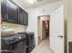 Functional laundry room with washer, dryer, and storage cabinets at 2022 W Briana Way, Queen Creek, AZ 85144