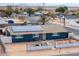 Aerial view of a blue house with solar panels and a fenced yard at 203 E Beech Ave, Casa Grande, AZ 85122