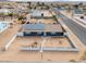 Aerial view of house with solar panels and fenced yard at 203 E Beech Ave, Casa Grande, AZ 85122