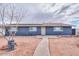 Blue house with solar panels and a walkway to the entrance at 203 E Beech Ave, Casa Grande, AZ 85122