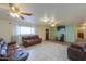 Spacious living area with brown couches and a large TV at 203 E Beech Ave, Casa Grande, AZ 85122