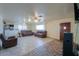 Living room featuring brown sofas, tile floors, and a partial bar view at 203 E Beech Ave, Casa Grande, AZ 85122