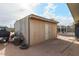 Tan colored storage shed in backyard at 203 E Beech Ave, Casa Grande, AZ 85122