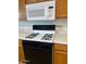 Close-up of kitchen appliances, including microwave and gas range at 205 N 74Th St # 205, Mesa, AZ 85207