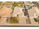 Aerial view showcasing a house with a three-car garage and solar panels in a neighborhood with pools at 20967 N 96Th Ln, Peoria, AZ 85382