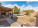 Inviting backyard oasis with a sparkling pool and covered patio at 20967 N 96Th Ln, Peoria, AZ 85382