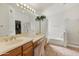 Main bathroom with double vanity, soaking tub, and separate shower at 20967 N 96Th Ln, Peoria, AZ 85382