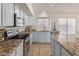 Modern kitchen with stainless steel appliances and light gray cabinets at 20967 N 96Th Ln, Peoria, AZ 85382