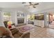 Relaxing living room with fireplace, large TV, and patio access at 20967 N 96Th Ln, Peoria, AZ 85382