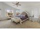 Main bedroom with a king-size bed, and an ensuite bathroom at 20967 N 96Th Ln, Peoria, AZ 85382