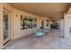 Covered patio with glass-top table and chairs at 20967 N 96Th Ln, Peoria, AZ 85382