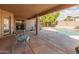 Covered patio with seating area, overlooking a sparkling pool and backyard at 20967 N 96Th Ln, Peoria, AZ 85382